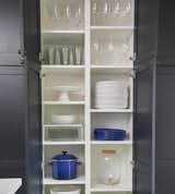 Floor-to-ceiling cabinets add ample storage space and also help hide any mess.