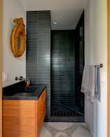 The guest bath features original brass-inlay terrazzo floors.