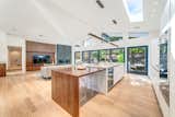 A wooden extension to the kitchen island provides additional dining space. All of the light wood flooring is new.