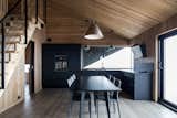 The open kitchen/dining area is a dramatic black.