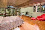 This bedroom takes advantage of the double-height ceiling and benefits from serene forest views.&nbsp;