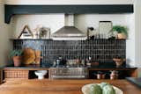 The owners of this updated Tudor-style abode in the Los Angeles neighborhood of Eagle Rock, Amanda and William Hunter, are the design duo behind the William Hunter Collective, which rehabs homes. Handmade tile, soapstone counters, walnut wood, and steel make up the artfully styled kitchen.