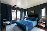 The master suite is a dark and moody retreat.&nbsp;