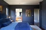 &nbsp;"It's okay to be bold," Henderson says of the indigo-hued bedroom. "I’m still under the impression that almost everyone loves blue, so I think this is not only okay to do, but actually something that can really add value." The color is French Beret from Benjamin Moore.