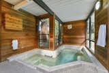 Tucked behind the shoji screens is a spectacular spa with cedar-paneled walls, large glass windows, and a sliding glass door leading to the backyard.