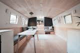 The minimalist boat is fitted with bespoke wall sconces and custom-made upholstery.