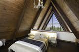The lofted bedroom enjoys a view of the treetops.