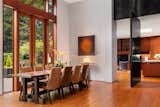 An oversized steel pivot door can close off the dining room.