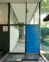 Overlooking a river in Weston, Connecticut, The Corwin House by noted midcentury architect Richard Neutra is one of the only Neutra homes in the state. "The house is so Neutra, yet in a more wooded setting and perched high above the river," says the listing agent Rick Distel. The front door is painted a royal blue and framed by glass windows.&nbsp;