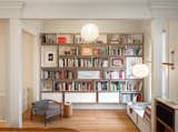 The family loves books. This wall of bookshelves was custom-designed by Bohlin Cywinski Jackson and fabricated by Tomlinson Woodworks. A bespoke reading nook is on the right.
