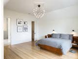 The light-filled master bedroom features hardwood floors and lighting from Mooi. 