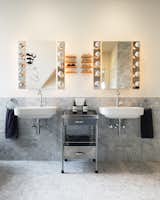 The bathroom features wall-mounted Duravit washbasins and custom shelves for eyeglasses.&nbsp;