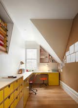 The home office features a laminate desk and cabinets in a bright, cheery yellow. They were designed by Bohlin Cywinski Jackson and made by Tomlinson Woodworks.
