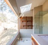 The master bath also features a sunken tub which is an extension of the hex-tile floor. The walls are covered in penny tiles. There is also an adjacent steam shower.