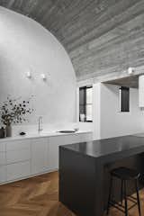 The kitchen countertop is made from black Zimbabwe granite. "The client loves to cook, so the island is the anchoring element that bridges the kitchen and the dining room," says Knights. The extended kitchen backsplash is made of Carrara marble.