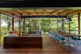 Billinkoff took advantage of the home’s thoughtful siting by adding a 600-square-foot screened porch adjacent to the dining room. Inserted into a steel frame, the porch is open on three sides and perched one story above the yard.