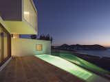 The home also features a narrow, in-ground swimming pool which is illuminated at night.