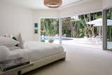 The master bedroom also features expansive glass sliders leading out to the pool area.&nbsp;