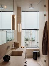 The vanities and bathroom walls are made from locally sourced travertine slabs.