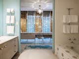 The master bath has a polka-dot soaking tub, and it opens to a dressing area.&nbsp;