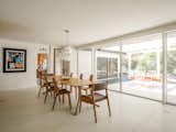 Oversized, full-height glass sliding doors provide easy access to the patio and a strong indoor-outdoor connection. The original terrazzo floors flow directly into the outdoors. 