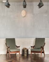 A pair of midcentury chairs in the lobby.  The wainscoting is repurposed from the building's original apartment doors. 