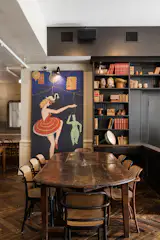 Communal tables at the back are intentional and meant to encourage social interaction between travelers picking up breakfast.