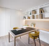 The office features built-in bookshelves and storage, plus a table by Jardin.&nbsp;
