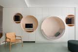 The owners of this 807-square-foot apartment in the Parisian suburb of Neuilly-sur-Seine tapped architect Pierre Louis Gerlier and interior designer Eleonore Satger to overhaul the cramped floor plan. Now, the living room wall discretely hides storage cabinets and features four circular built-ins, one of which serves as a cozy reading nook.&nbsp;&nbsp;