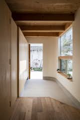 The entrance to the home—the genkan—is where guests remove their shoes in a Japanese house. Here, it conveniently features built-in storage cabinets. 