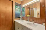 The second bath has also had minor updates but retains the original wood-paneled walls.&nbsp;