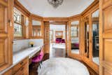 A birdseye maple dressing room with stained glass windows and chic marble countertops transports you back in time.&nbsp;