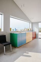 For this kitchen renovation, the homeowners decided on cabinets designed by Ghent-based duo Muller Van Severen for Reform, a Danish company that elevates Ikea kitchens with designer fronts. The panels are made from durable, wax-like, high-density polyethylene (HDPE)—a plastic traditionally used in cutting boards, and Muller Van Severen’s signature material. "We have always felt a love for polyethylene, with its powerful colors," explains Fien Muller. "It is not a dead plastic with a cold and smooth surface. It has a soft and warm appearance that invites you to touch."