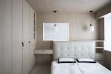 In the master bedroom, Bean Buro encased the couple’s existing bed in a timber unit. The JWDA Pendant is by Menu.&nbsp;