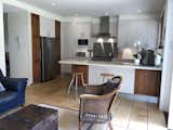 The wall between the kitchen and the dining area was taken down to create one larger open-plan space.   Photo 6 of 17 in Before & After: A Partitioned Bed-and-Breakfast in Sydney Is Now a Gracefully Unified Home