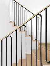 The staircase handrail was custom designed by Unicus Developments specifically for this renovation. It’s constructed from a combination of iron and unlacquered brass. The craftsman applied a step notch—a linear cutout—to each stair tread.
