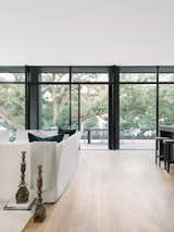 The upstairs level holds three of the home’s four bedrooms and a “tree room” surrounded by canopy views. 

