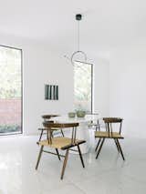 An additional dining area boasts George Nakashima chairs and lighting from Flos.