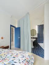The master bedroom has an ensuite bath set behind a curtain.&nbsp;