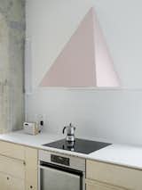 Color was a fundamental element of the project and the pink range hood certainly makes a bold statement. The birch plywood boards that are used for the kitchen cabinetry match the flooring and reflect the firm's embrace of DIY techniques&nbsp;
