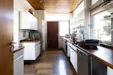 The original Bulthaup kitchen is a mix of white cabinetry and wood countertops.&nbsp;