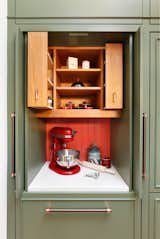 The pantry doors open to reveal an extra-high level of customization where every inch of storage space is thoughtfully accounted for. What looks like two pull-out drawers below the space are actually three drawers, as one door actually containing two drawers inside it. 