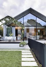 The back of the home and its soaring glass-and-concrete addition create a strong connection between the indoor and outdoor spaces, and the rear garden and the pool feel like "a secret refuge."