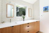 The sun-filled master bathroom features updated tile and fixtures.