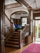 A seating nook on the staircase showcases the pillows that the firm made from the vintage silk scarves they found online—a detail that helped inform the color palette for the project. 