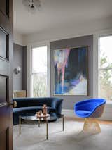 The home office  is a showcase for an electric blue Warren Platener lounge chair from Hive Modern, paired with a vintage Vladimir Kagan Serpentine Cloud sofa. The painting is by Michelle Betancourt. 