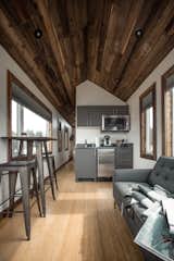 A pitched, tongue-and-groove ceiling adds a rustic feel.&nbsp;