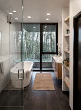 The light-filled master bathroom features a deep soaking tub.&nbsp;