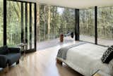 The master bedroom is wrapped in walls of glass, including glass sliding doors that lead out to a wraparound terrace that has enough room for patio furniture.&nbsp;