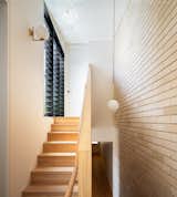 The staircase leads to the upper level and features lighting from Flos.&nbsp;